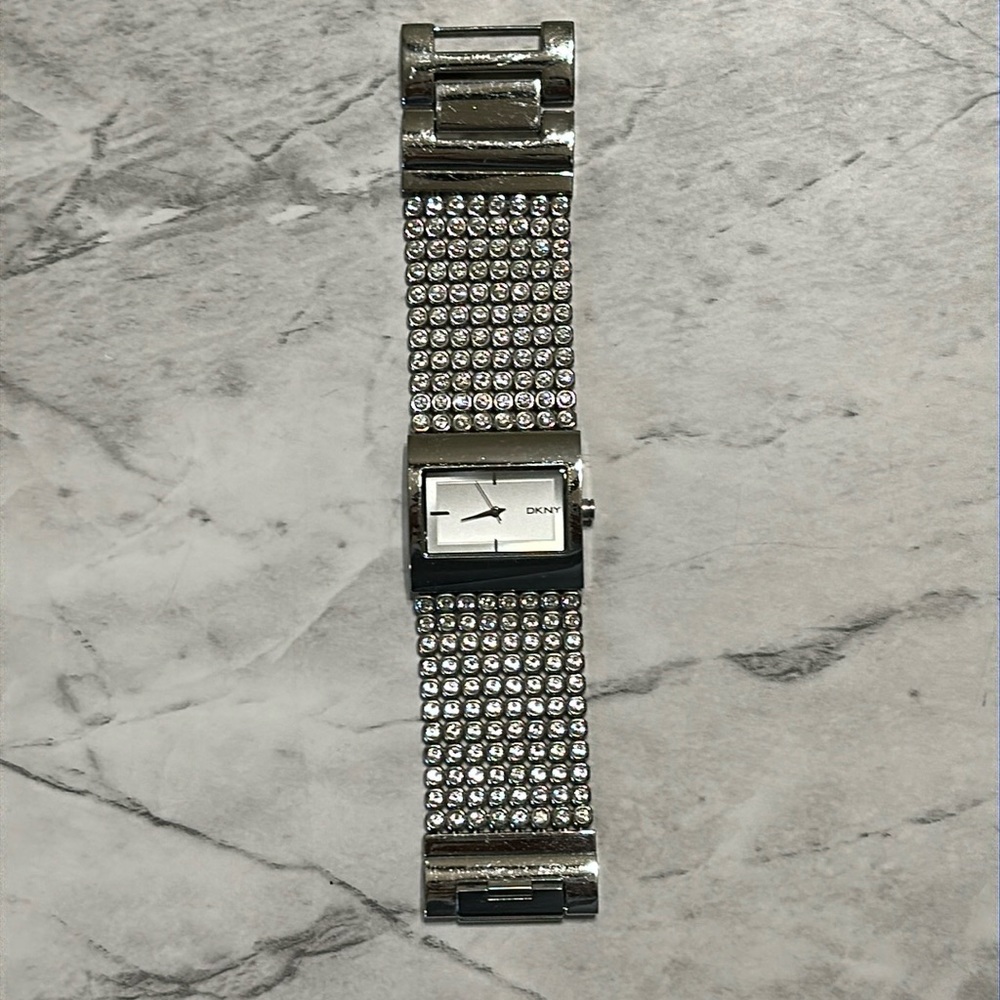 DKNY watch. Sparkling rhinestones. Needs new batter. 6 1/2” in diameter.